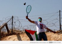 Playing tennis to return tear gas canisters to Israeli troops.